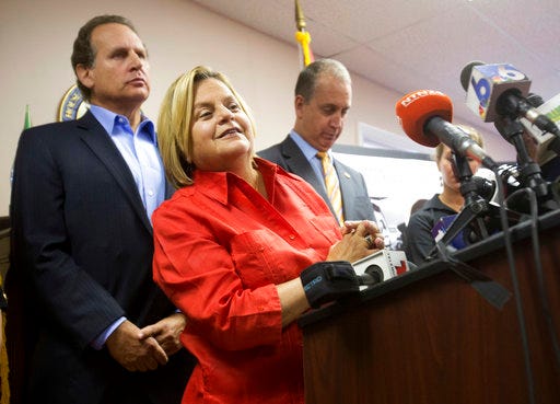 FILE - In this Wednesday, Aug. 12, 2015, file photo, U.S. Rep. Ileana Ros-Lehtinen, R-Fla., center, listens to a question from the media as she is joined by U.S. Rep. Mario Diaz-Balart, R-Fla., right, and his brother, former Congressman Lincoln Diaz-Balart, during a news conference, in Miami. Ros-Lehtinen of Florida, the first Cuban-American elected to Congress, is retiring at the end of her term next year, saying it's time to move on after 38 years in office. The Miami Herald first reported the retirement Sunday, April 30, 2017. (AP Photo/Wilfredo Lee, File)