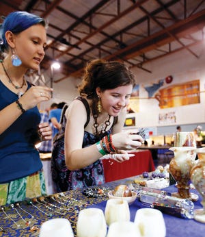 Photo by Tracy Klimek/New Jersey Herald - 
Vlada Petrola, left, and Dominika Sluszkiewicz, both of the Bronx N.Y., look at minerals that are found in Mount Ganesh, Nepal, at vendor Rakche Tamang's table Saturday during the annual Spring Gem and Mineral Show, at Franklin Elementary School.