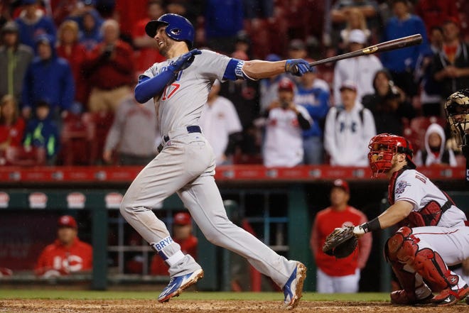 The Cubs' Kris Bryant hits an RBI sacrifice fly during a game against Cincinnati earlier this month.