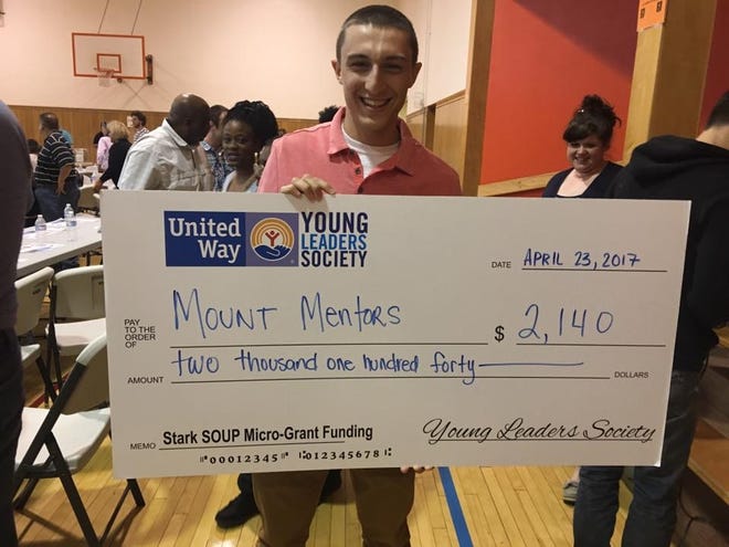 Stephen Dages shows off the check for $2,140 he reveived April 23 at the Stark SOUP event in Canton. Dages will use the funds to support the Mount Mentors program he launched at the University of Mount Union.. (Photo courtesy of Pathway Caring for Children)