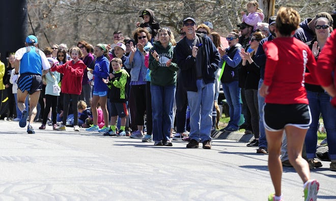 Runners pass the sidelines of cheering fans heading to the finish line during Sunday's West Island 5k in Fairhaven. [DAVID W. OLIVEIRA/STANDARD-TIMES SPECIAL/SCMG]