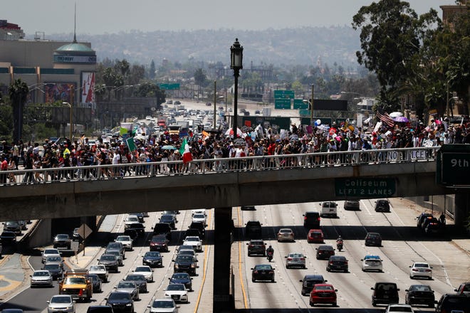 Thousands of protesters march over the 110 Freeway during a May Day rally Monday, May 1, 2017, in Los Angeles. THE ASSOCIATED PRESS