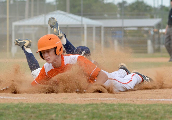 Dust flies as Mount Dora's Brody Holtman slides back to first base during a game against Eustis at Stuart Cottrell Field on Monday in Eustis. [AMBER RICCINTO / DAILY COMMERCIAL]