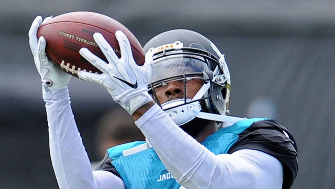 Jaguars wide receiver Tony Washington (12) catches a pass during drills Aug. 2 in Jacksonville. (Bob Mack/Florida Times-Union)