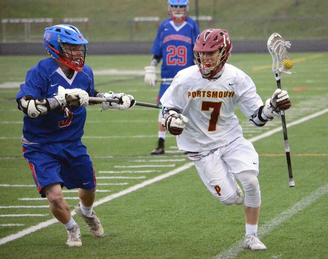 Portsmouth's Ryan Groleau (7) looks to gain an edge on a Londonderry defender along the sideline during Monday's boys lacrosse game at PHS.