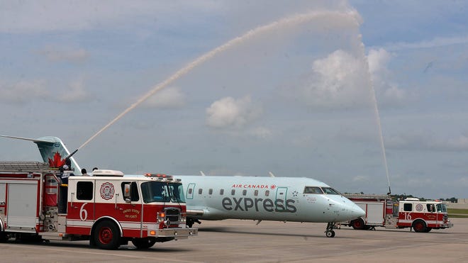 Fire trucks gives a water cannon salute to an Air Canada plane on its’ first flight from Toronto to the Savannah/Hilton Head International airport. (Steve Bisson/Savannah Morning News)
