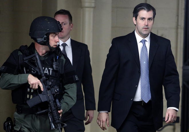 FILE - In this Monday, Dec. 5, 2016, file photo, former South Carolina police officer Michael Slager, right, walks from the Charleston County Courthouse under the protection of the Charleston County Sheriff's Department after a mistrial was declared for his trial in Charleston, S.C. Slager is pleading guilty to violating the civil rights of an unarmed black motorist he shot and killed during a 2015 traffic stop. A copy of the plea agreement obtained by The Associated Press Tuesday, May 2, 2017, also shows state prosecutors are dropping a pending murder charge against Slager. (AP Photo/Mic Smith, File)