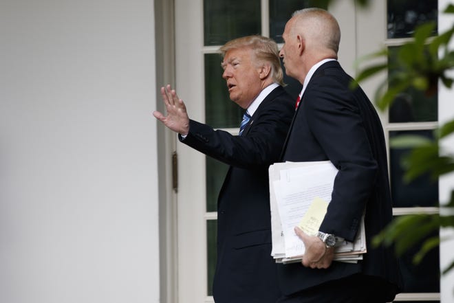 President Donald Trump walks with aide Keith Schiller to the Oval Office of the White House in Washington, Tuesday, May 2, 2017. THE ASSOCIATED PRESS