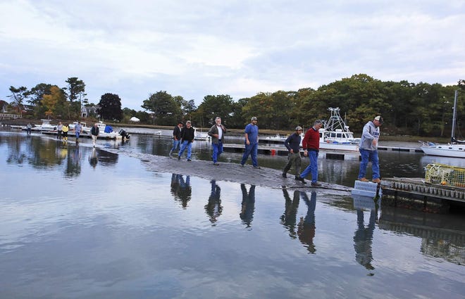 York officials, including Harbor Board members, walk along a sand bar in York Harbor last October to demonstrate the need for dredging in the harbor. [Jill Brady photo, file]