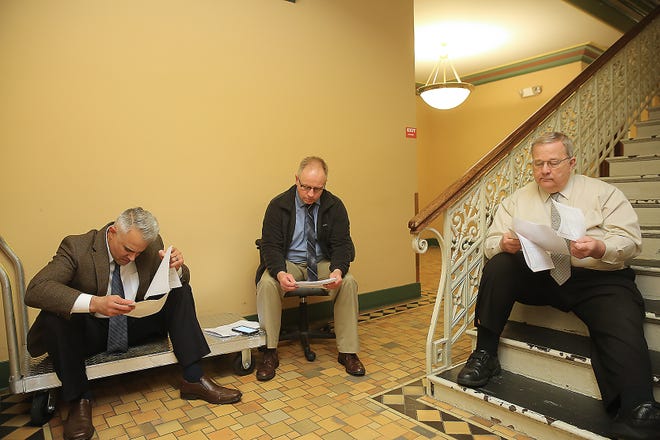 Tuscarawas County Commissioners Joe Sciarretti, Chris Abbuhl and Kerry Metzger look over early primary election results at the Tuscarawas County Courthouse Tuesday evening. (TimesReporter.com / Jim Cummings)