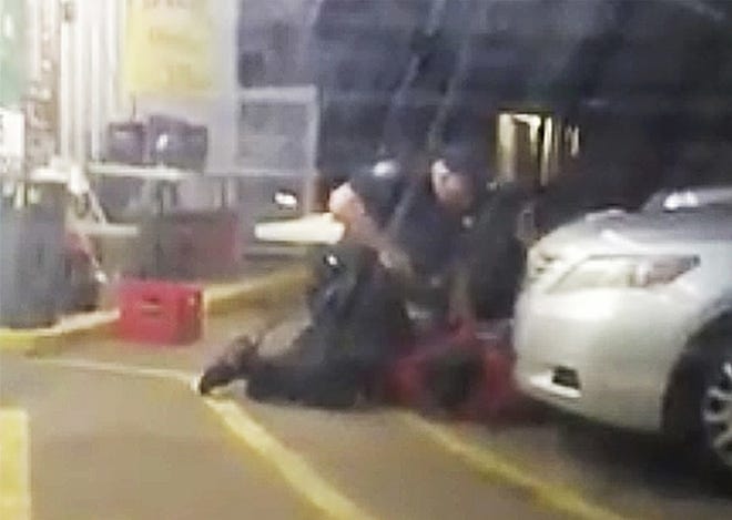 In this Tuesday, July 5, 2016 image made from video, Alton Sterling is restrained by two Baton Rouge police officers, one holding a gun, outside a convenience store in Baton Rouge, La. Moments later, one of the officers shot and killed Sterling, a black man who had been selling CDs outside the store, while he was on the ground. Officers Blane Salamoni and Howie Lake II were placed on administrative leave. Neither has been charged. The U.S. Justice Department decided not to charge the two officers, according to a person familiar with the decision who disclosed it to the AP on Tuesday, May 2, 2017. Federal authorities opened a civil rights investigation immediately after the shooting. The Justice Department's decision doesn't preclude state authorities from conducting their own investigation and pursuing their own criminal charges. THE ASSOCIATED PRESS