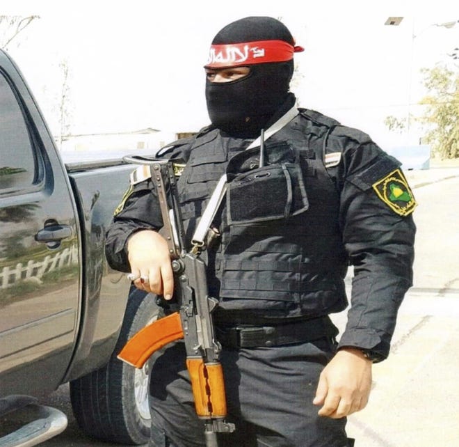 This undated photo obtained by the Associated Press shows an Iraqi bodyguard hired by Sallyport Global to protect VIPs. When a Toyota SUV was stolen from Balad air base, he became the chief suspect and was linked to a dangerous Iran-backed militia and was viewed by investigators as "a hard-core recruit to become a terrorist who poses a serious threat to all personnel on this base." [AP PHOTO]