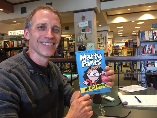 Nationally syndicated cartoonist Mark Parisi shows off his first book, “Marty Pants: Do Not Open!” (Peter Chianca)