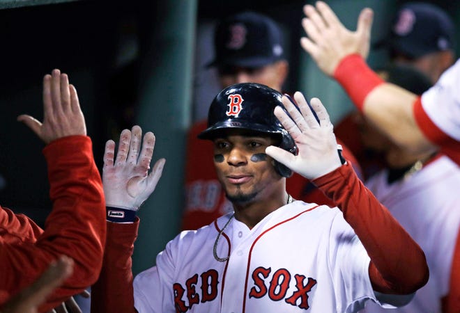 Xander Bogaerts is congratulated by teammates after scoring on a double by Chris Young during the fourth inning on Wednesday night.