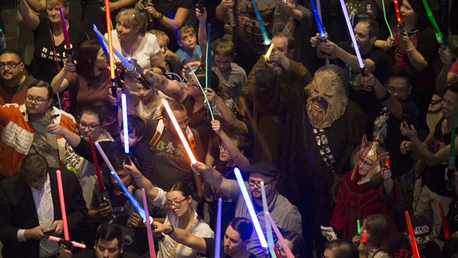 Star Wars fans gathered for a lightsaber vigil to honor the late actress and writer Carrie Fisher at the Alamo Drafthouse South Lamar on Dec. 28. Stephen Spillman / for AMERICAN-STATESMAN