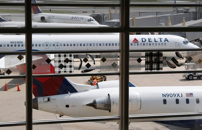 In this Monday, Aug. 8, 2016, file photo, Delta Air Lines planes are parked at Ronald Reagan Washington National Airport, in Washington. A California family says they were forced off a Delta plane and threatened with jail after refusing to give up one of their children’s seats on a crowded flight. A video of the April 23, 2017, incident was uploaded to Facebook on Wednesday, May 3, 2017, and adds to the list of recent encounters on airlines that went viral, including the dragging of a passenger off a United Express plane. (AP Photo/Carolyn Kaster, File)