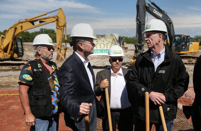 From left, Third Ward Councilman Karl Skala and Mayor Brian Treece talk to Doug Geshell, plant manager at Aurora Organic Dairy's Platteville, Colo., facility, and Floyd Carpenter, a project manager for Aurora's planned Columbia milk and butter processing plant, after a groundbreaking ceremony on Waco Road on Thursday. The new plant is expected to open in December 2018. [Timothy Tai/Tribune]