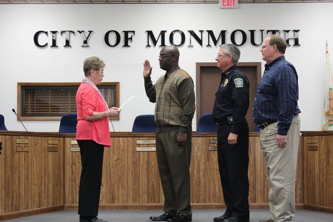 Monmouth City Clerk Susan S. Trevor, left, swears in new police officer Marlon Williams, second from left, on Monday night. Looking on are Monmouth Police Chief Bill Feithen and Mayor Rod Davies.