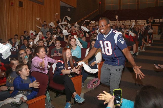 New England Patriots player Matthew Slater greets students during an assembly to talk about character education. [Photo/Courtesy]