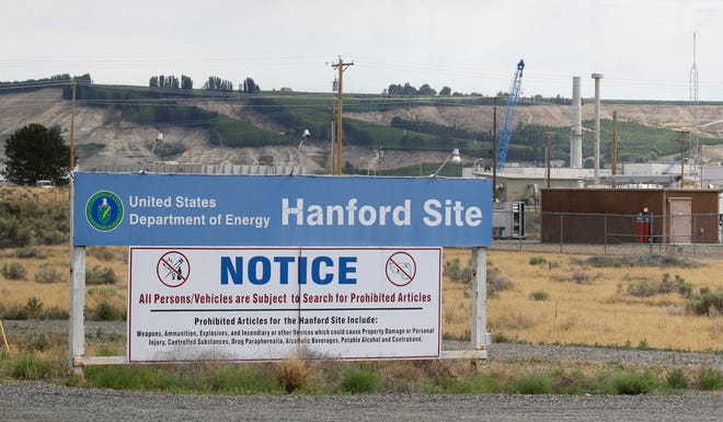 FILE - In this July 9, 2014, file photo, a sign informs visitors of prohibited items on the Hanford Nuclear Reservation near Richland, Wash. A new report says Congress should consider authorizing the Department of Energy to use grout to stabilize some of Hanford's radioactive waste, rather than a more expensive plan to turn it into glass. (AP Photo/Ted S. Warren, File)