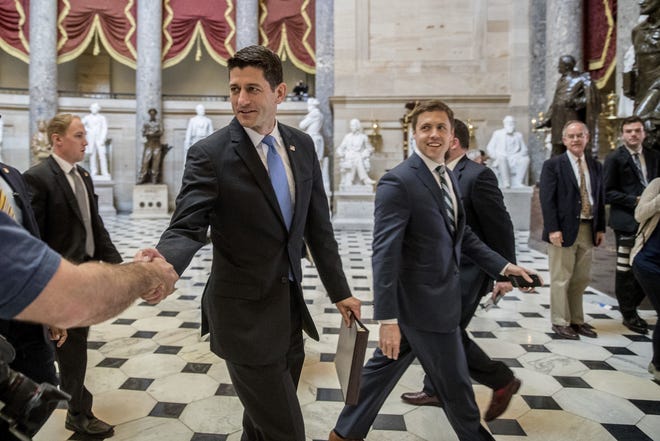 House Speaker Paul Ryan of Wis. greets guests as he walks to the House Chamber on Capitol Hill in Washington, Thursday, May 4, 2017. The Republican health care bill, a top-flight priority the party nearly left for dead six weeks ago, cleared the House after a showdown vote. THE ASSOCIATED PRESS