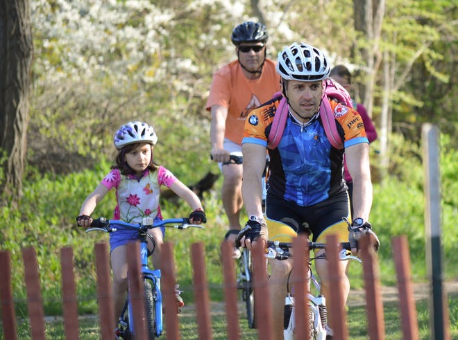 Many Stratham parents and relatives are again expected to ride alongside their kids during this year's Bike to School Day. [File photo]