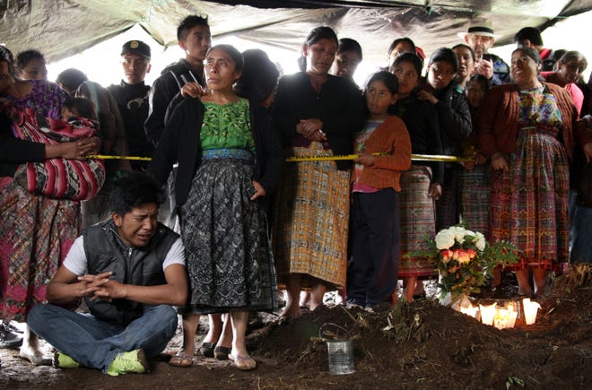 The community watches on during an exhumation in Xepol, Guatemala, in the documentary "Finding Oscar."

[FilmRise]