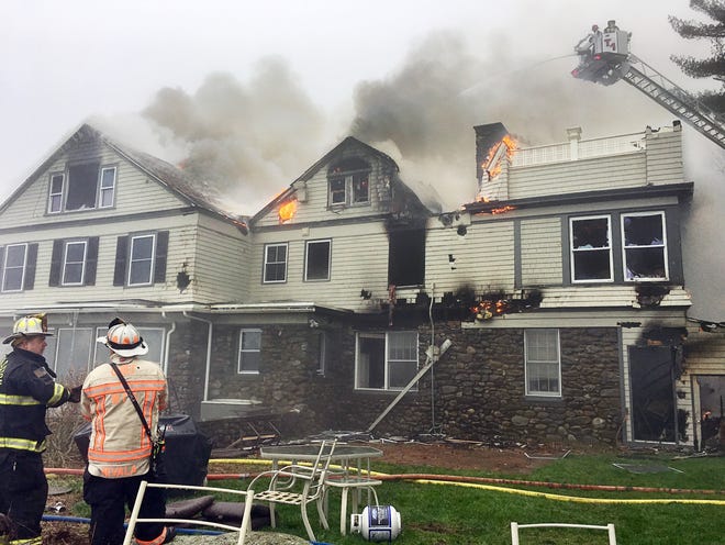 Firefighters battle a blaze at 30 Mountain Rd., Princeton, Tuesday. [T&G Staff/Christine Peterson]