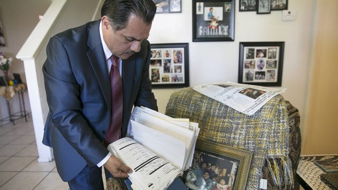 Ali Amron looks through a stack of legal and personal files pertaining to the death of his son. Jamail Amron died after an incident with Harris County constables on Sept. 30, 2010.