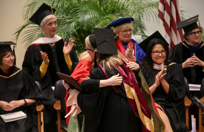President Dianne Lynch, left, hugs graduate commencement speaker Sarah Whorton during Stephens College's graduate and online student commencement ceremony Friday at Lela Raney Wood Hall. The graduation included the first cohort of students, including Whorton, from Stephens' master of arts in television and screenwriting program. [Timothy Tai/Tribune]