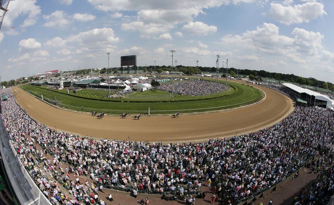Taken with a fisheye lens, fans watch a race before the 141st running of the Kentucky Derby horse race at Churchill Downs on May 2, 2015, in Louisville, Ky. Churchill Downs' parent company has pumped $250 million into renovations since the early 2000s. But many have catered to well-heeled fans willing to shell out thousands of dollars for panoramic views, sumptuous buffets, access to betting windows and restrooms without lines, and demand outpaces available seating. That's leaving the middle class squeezed out. [AP Photo / Charlie Riedel, File]