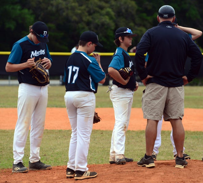 Destin Coach Daniel Griffin huddles up the infield on the mound about midway of the fourth inning. Ruckel exploded on the Marlins in the fourth scoring 11 runs for an 18-4 victory in the Okaloosa County Middle School Baseball Championship game. [TINA HARBUCK/THE LOG]