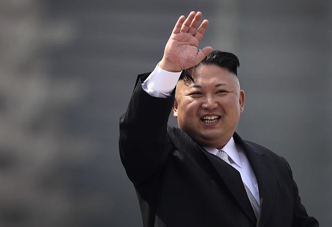 In this Saturday, April 15, 2017, file photo, North Korean leader Kim Jong Un waves during a military parade in Pyongyang, North Korea, to celebrate the 105th birth anniversary of Kim Il Sung, the country's late founder and grandfather of current ruler Kim Jong Un. North Korea has accused the U.S. and South Korean spy agencies of an unsuccessful assassination attempt on leader Kim Jong Un involving bio-chemical weapons. THE ASSOCIATED PRESS