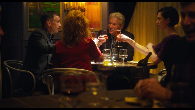Steve Coogan, Laura Linney, Richard Gere, and Rebecca Hall enjoy one of the very few light moments in Oren Moverman’s tale of madness. (Photo courtesy of The Orchard)