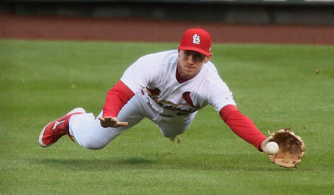 St. Louis Cardinals right fielder Stephen Piscotty dives for a single by Milwaukee Brewers' Keon Broxton in the second inning of a baseball game against the Milwaukee Brewers in St. Louis on Thursday, May 4, 2017. (Chris Lee/St. Louis Post-Dispatch via AP)