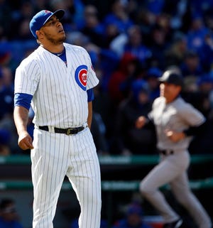 Chicago Cubs relief pitcher Hector Rondon, left, reacts as New York Yankees' Brett Gardner, right, rounds the bases after hitting a three-run home run during the ninth inning of an interleague baseball game Friday, May 5, 2017, in Chicago. (AP Photo/Nam Y. Huh)