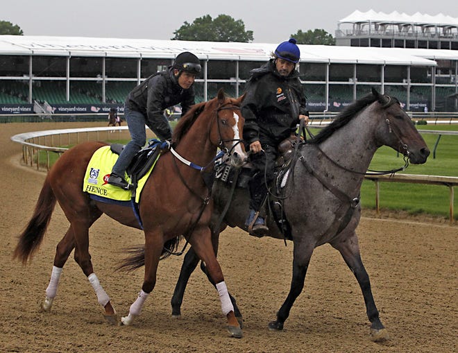 Trainer Steve Asmussen, right, leads Kentucky Derby entrant Hence, with rider Angel Garcia out onto the track for a morning workout at Churchill Downs in Louisville, Ky. on Thursday. The Kentucky Derby is set for Saturday. [AP Photo/Garry Jones]