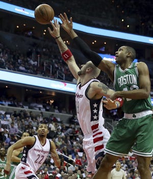 Wizards center Marcin Gortat shoots over Celtics center Al Horford during the first half of Washington's 116-89 win Thursday. [ANDREW HARNIK/THE ASSOCIATED PRESS]