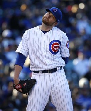 Chicago Cubs starting pitcher Brett Anderson reacts after New York Yankees' Aaron Hicks bunted during the first inning of an interleague baseball game Saturday, May 6, 2017, in Chicago. (AP Photo/Nam Y. Huh)