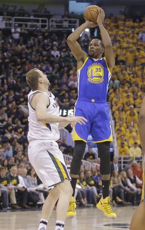 Golden State forward Kevin Durant (35) scored 38 points and collected 13 rebounds as the Warriors beat the Jazz 102-91 in Game 3 of the teams' second-round playoff series. [Rick Bowmer/The Associated Press]
