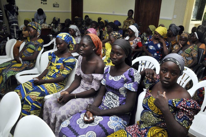 Chibok school girls recently freed from Boko Haram captivity are seen in Abuja, Nigeria, Sunday, May 7, 2017. The 82 freed Chibok schoolgirls arrived in Nigeria's capital on Sunday to meet President Muhammadu Buhari as anxious families awaited an official list of names and looked forward to reuniting three years after the mass abduction. (AP Photo/ Olamikan Gbemiga)