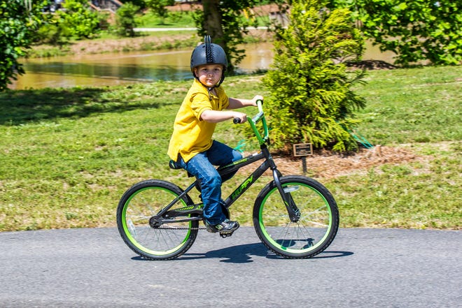 Saturday's Goat Island Games brought out young competitors in an array of outdoor games. Here a young bicyclist takes a ride. [PHOTO BY BILL BOSTICK/SPECIAL TO THE GASTON GAZETTE]