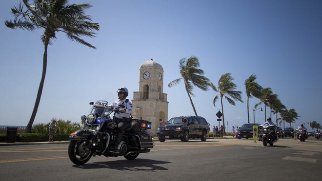 President Donald J. Trump’s motorcade passes the clocktower at Worth Avenue and S. Ocean Boulevard on his way to Easter service at Bethesda-by-the-Sea Episcopal Church in Palm Beach, Florida on April 16, 2017. (Allen Eyestone / The Palm Beach Post)