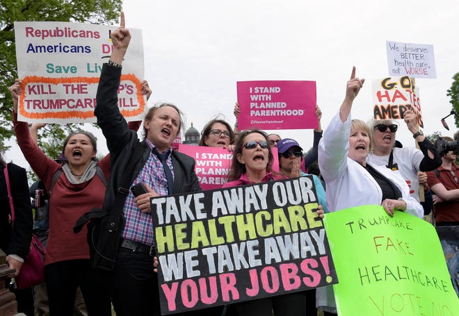Protesters chant as Republican and Democratic House members walk down the steps of the Capitol in Washington on Thursday after the Republican health care bill passed in the House. (AP Photo/Susan Walsh)