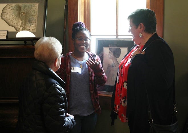 Student artists from Zeeland East and Zeeland West High schools talk to potential patrons during the first "Art Te Leen" gala on May 1. Student artwork has been leased and put on display by local businesses for a year. [Contributed]