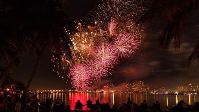The BB&T fireworks from SunFest sparkle over downtown West Palm Beach and reflect on the Intracoastal Waterway to the shores of Palm Beach on May 7. (Greg Lovett / Daily News)