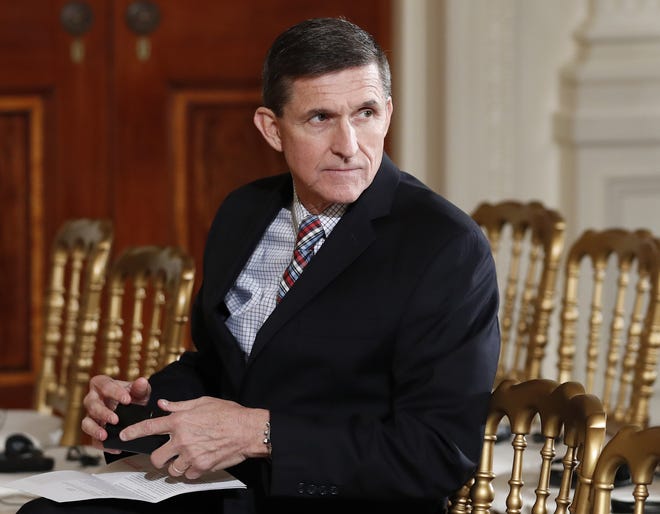 In this Feb. 10, 2017 file photo, then-National Security Adviser Michael Flynn sits in the East Room of the White House in Washington. A member of Donald Trump's transition team asked national security officials in the Obama White House for the classified CIA profile on Russia's ambassador to the United States. The unusual request appears to signal that Trump's own team had concerns about whether his pick for national security adviser, Mike Flynn, fully understood that he was dealing with a man rumored to have ties to Russian intelligence agencies. THE ASSOCIATED PRESS