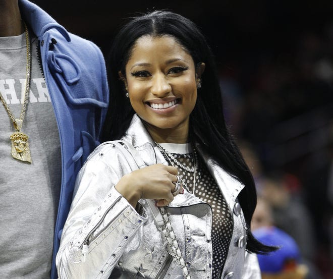 FILE - In this Jan. 16, 2016, file photo, Musician Nicki Minaj is seen in Philadelphia. Minaj promised to pay college costs for more than a dozen fans who tweeted her on Saturday, May 6, 2017. THE ASSOCIATED PRESS