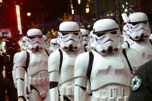 In this Dec. 16, 2015, file photo, people dressed as stormtroopers walk on the red carpet upon arrival at the European premiere of the film 'Star Wars: The Force Awakens' in London. Multiple stories on sites resembling local affiliate TV stations have published false casting calls claiming the a Star Wars movie is going to be filmed towns across the United States, interchanging the name of the town and promoting a new movie about a previously unknown planet in the Star Wars universe. The only Star Wars movie in production in May 2017 is the untitled Han Solo Film, which began shooting in January outside London.