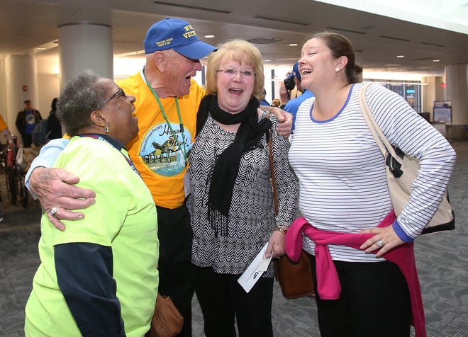 World War II veteran Bill Wilkens laughs with Carrie Carter, left, of the Honor Flight program at Baltimore Washington International, and Inez Bergerson and Aimee McCormick, both from Mobile, Ala., upon arrival at the Baltimore Washington International Airport in Baltimore, Md. on May 11, 2016. [Staff photo | Erin Nelson]